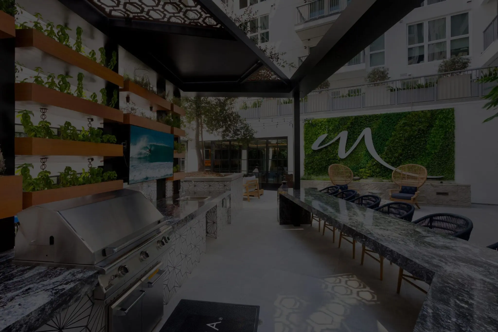 Outdoor kitchen and dining space at Mill Creek apartment community with upscale amenities & multifamily investment focus.